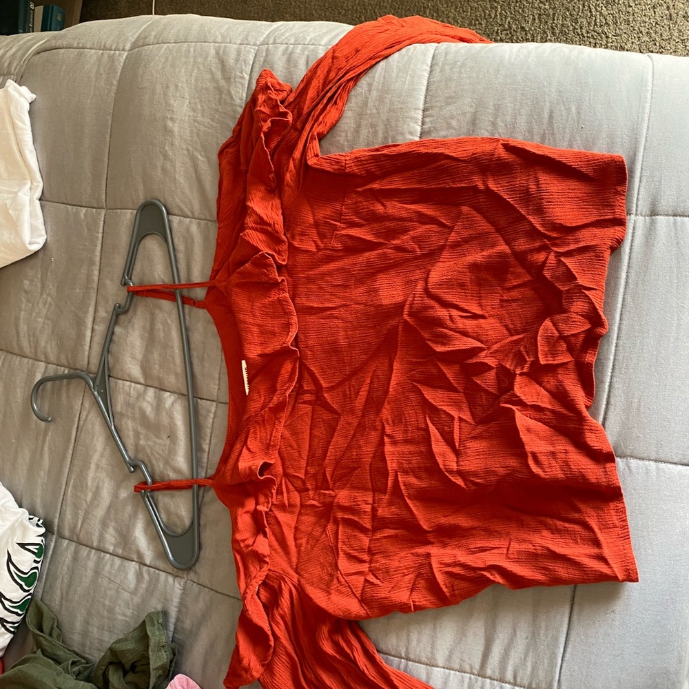 Orange ruffle off the shoulder shirt